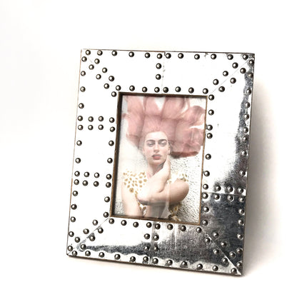 Silver coloured metal picture frame with bolts and industrial style